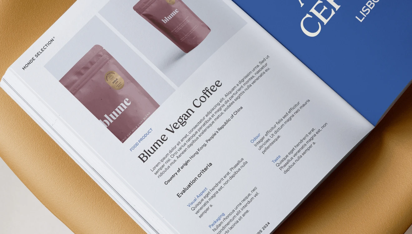 Mockup visualization of a page from the catalog of Monde Selection Quality Awards on a chair. Realized for the Monde Selection Rebranding Project. Design by Nemesis Studio and Fabio Besti