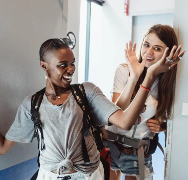 Ostello Bello Brand Experience & Design Innovation_ Excited guests entering rooms, while hifiving and smiling to each other - Fabio Besti & Domus Academy Workshop