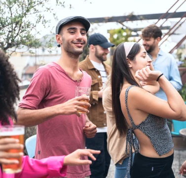 Ostello Bello Brand Experience & Design Innovation_ Rooftop aperitivo in Milan, with people dancing and interacting joyfully - Fabio Besti & Domus Academy Workshop