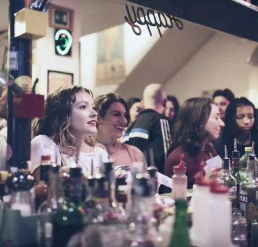 Ostello Bello Brand Experience & Design Innovation_ Ostello Bello duomo. Girls ordering drinks at the bar - Fabio Besti & Domus Academy Workshop