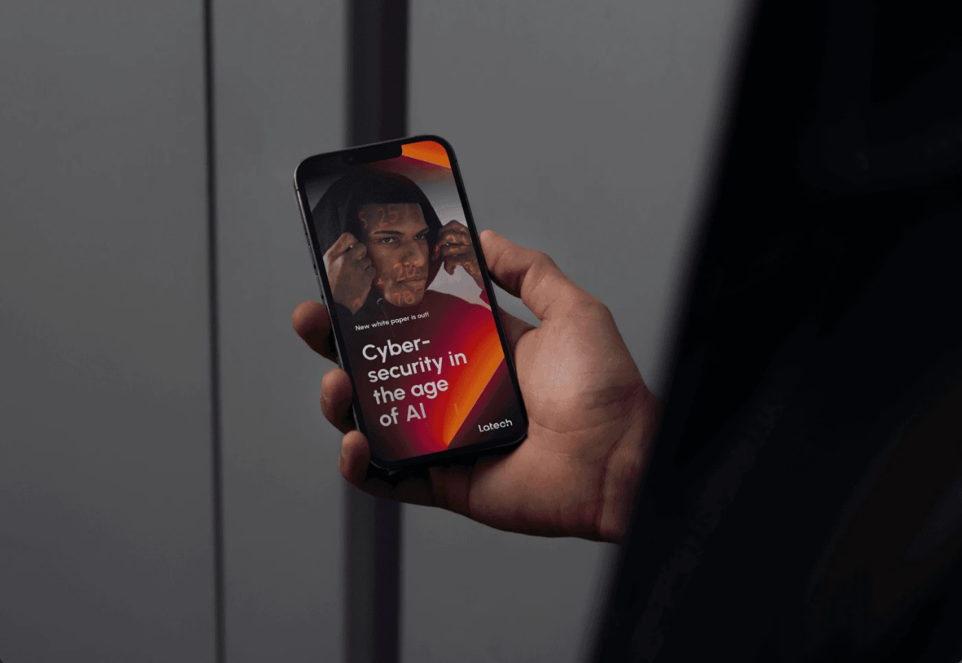 Mockup of a hand held iPhone 16, with a visualisation of a white paper vertical cover Cybersecurity in the age of AI, part of the Latech (Stravos) project, a Tech startup rebrand by Fabio Besti Interdisciplinary Design for Nemesis Agency